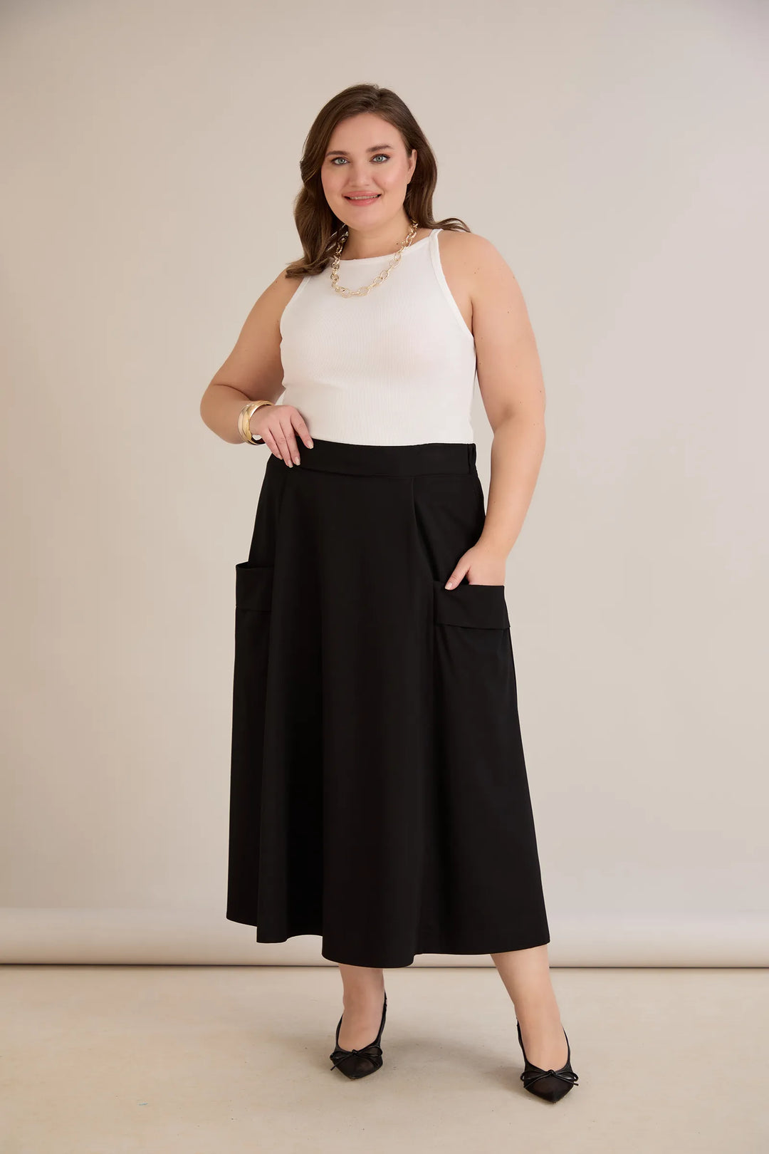 Sportsko-elegantna midi suknja s džepovima