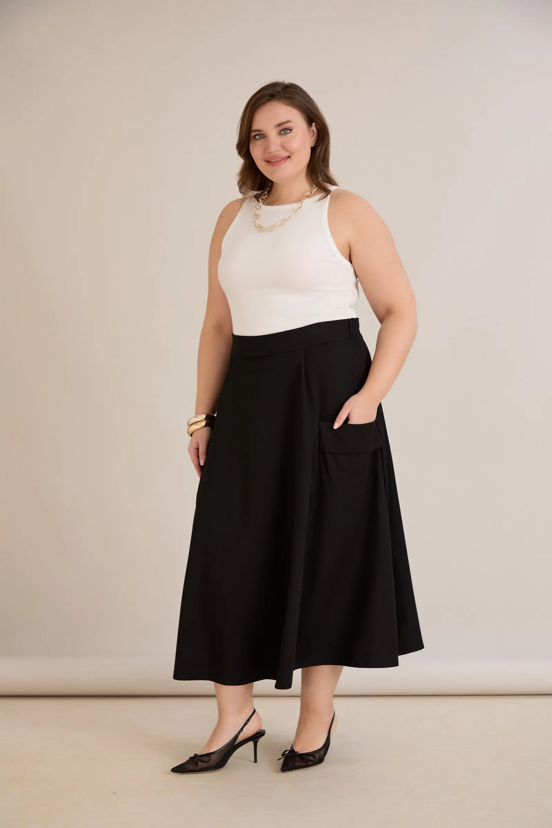 Sportsko-elegantna midi suknja s džepovima