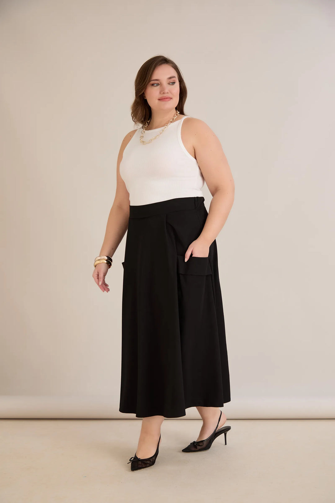 Sportsko-elegantna midi suknja s džepovima