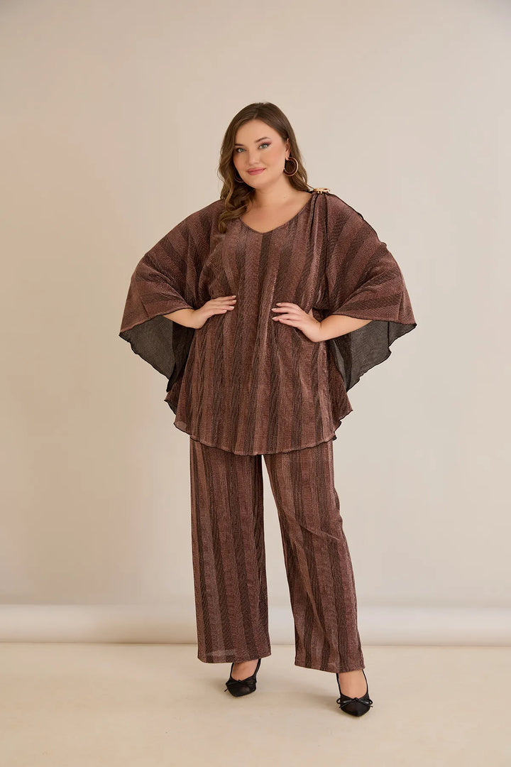 Elegantan set s prorezom na rukavu i sofisticiranim brošem